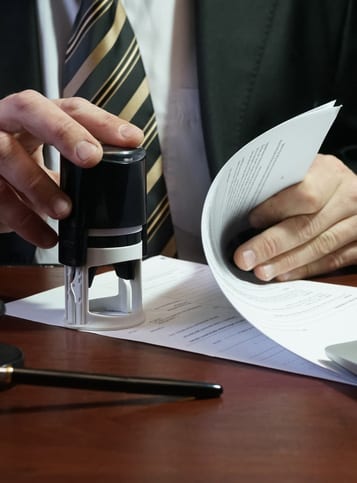 The businessman puts a stamp on the contract